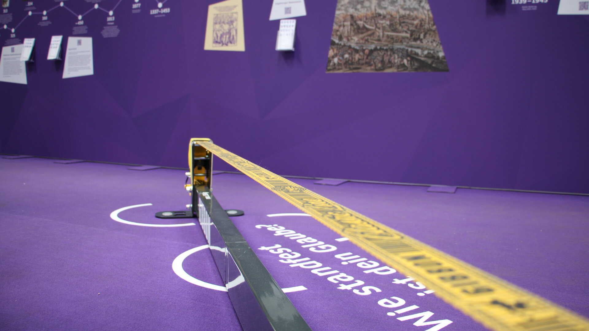 Eine gelbe Slackline auf violettem Teppich